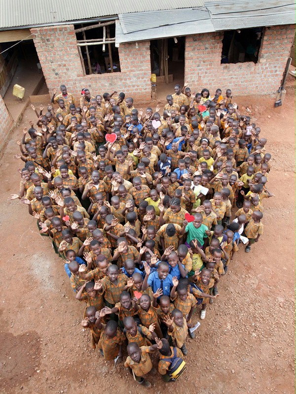 Schoolchildren have positioned themselves in the shape of a heart.