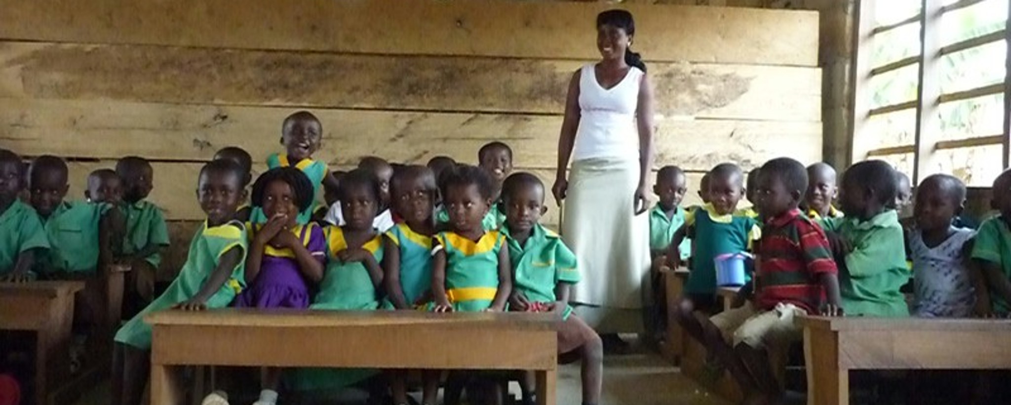 School kids are in the classroom with their teacher.