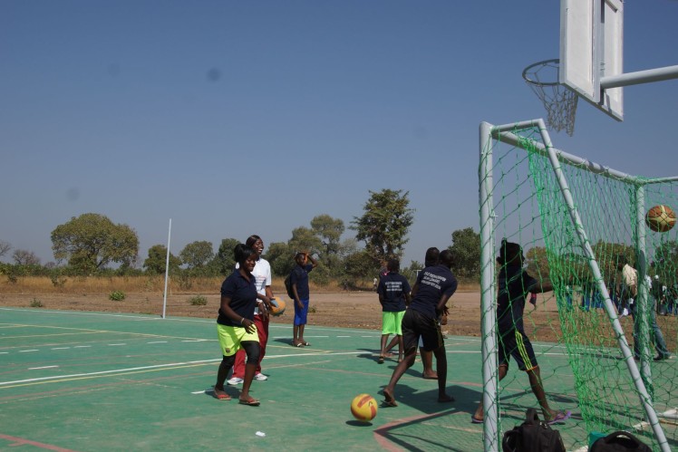 Students play basketball.