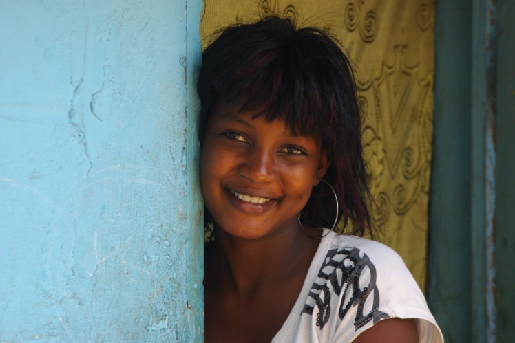 A girl smiles into the camera.