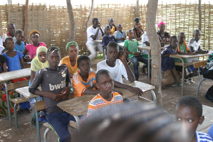 The students sit in the classroom.