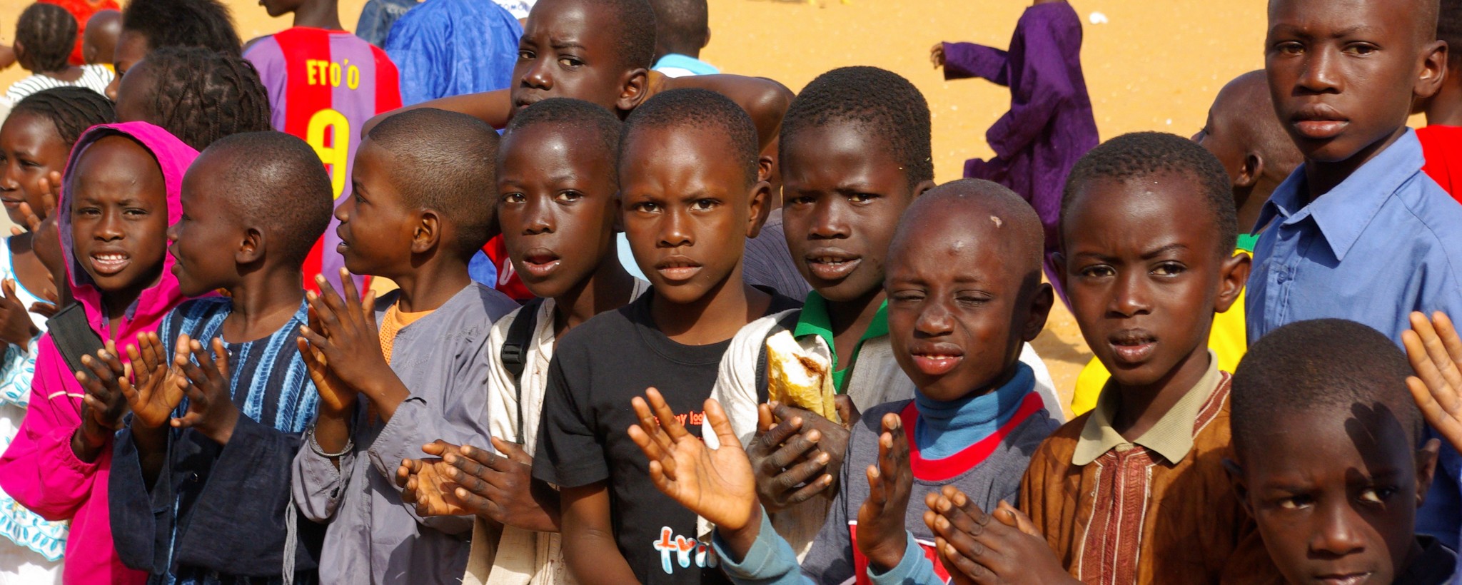 A group of children clap their hands.