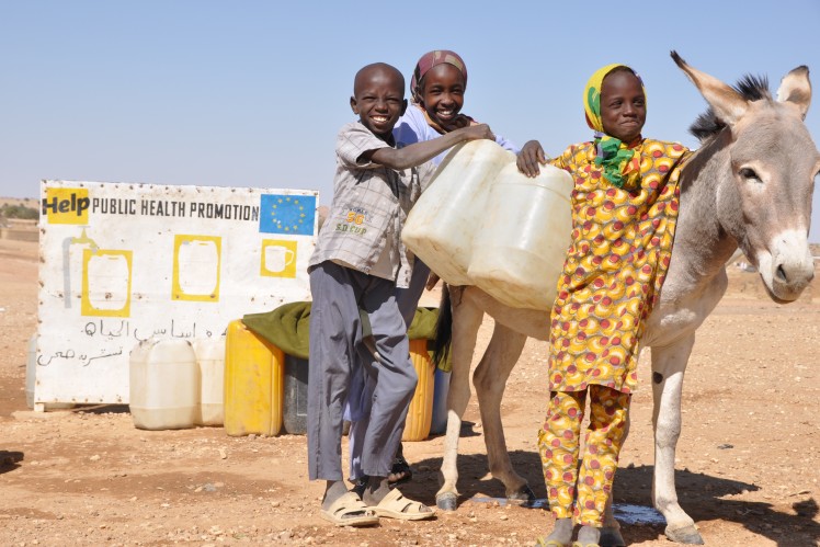3 black children fetching water with the help of a donkey
