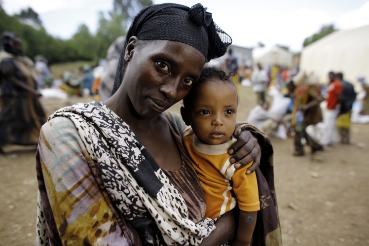 Woman holding her little child in her arms.