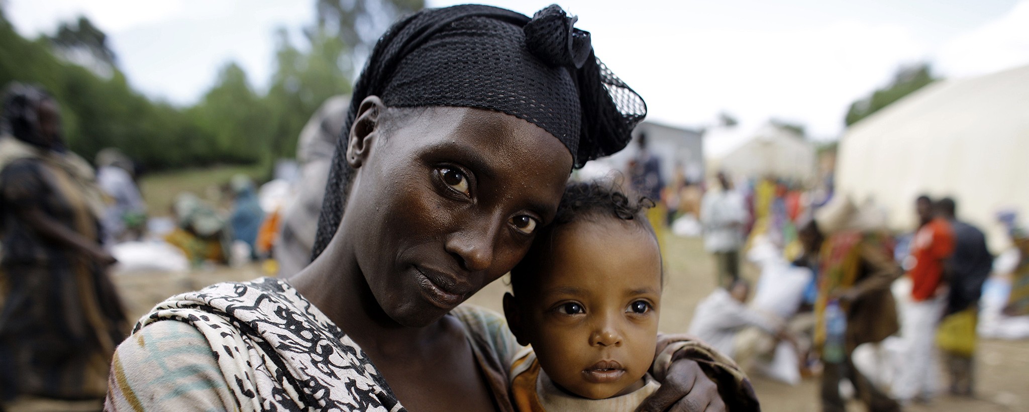 Woman holding her little child in her arms.