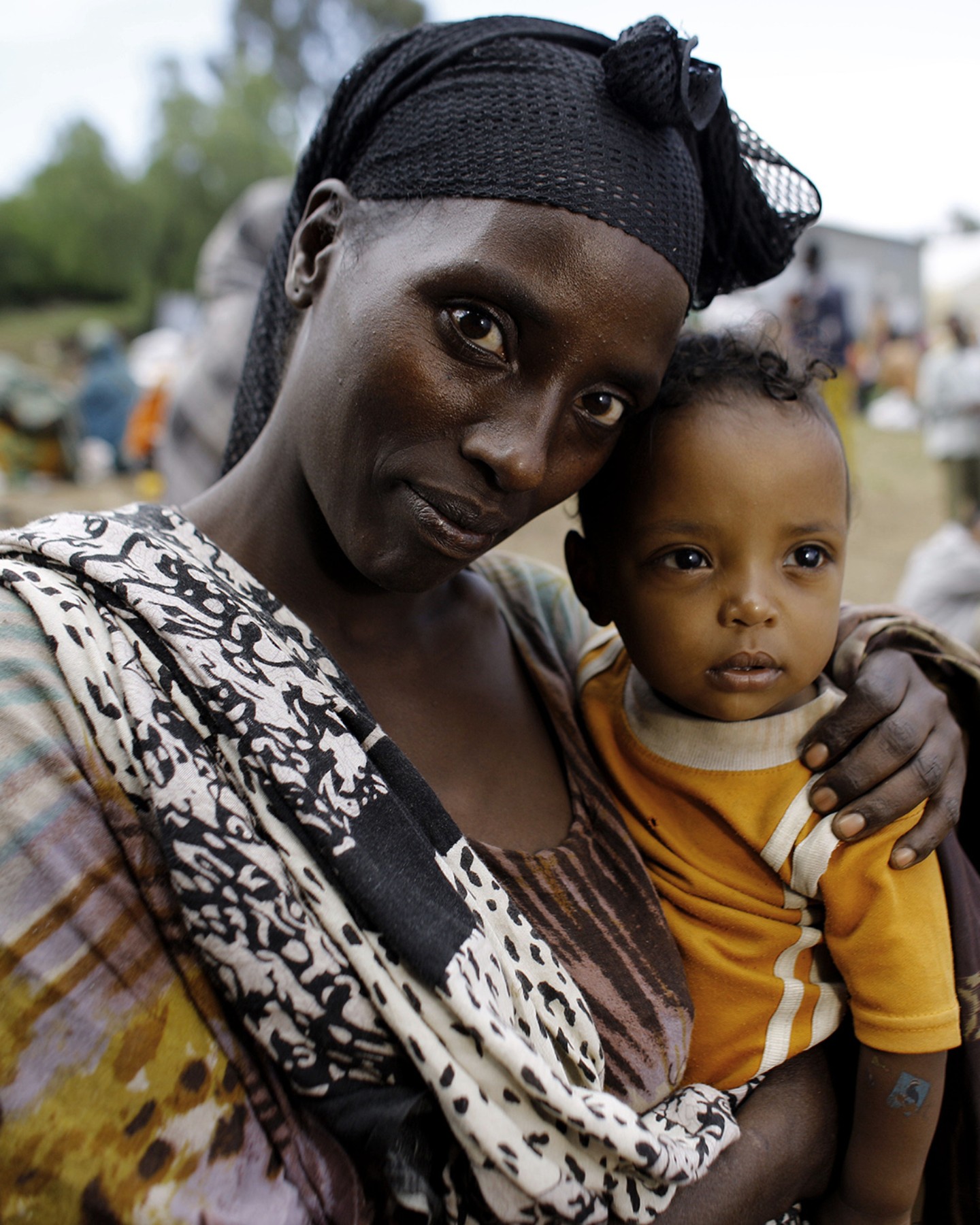 Woman holding her little child in her arms.