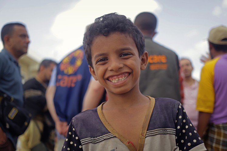 A young boy is smiling.