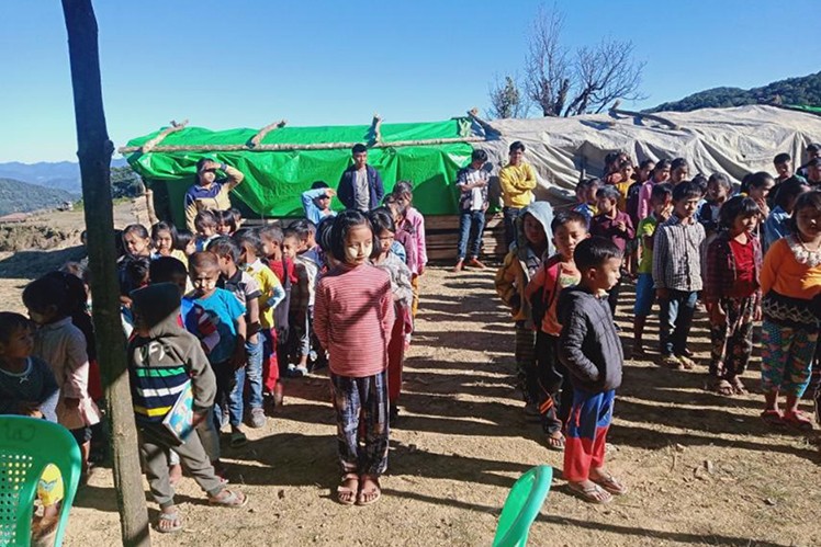 Children in Myanmar receiving food